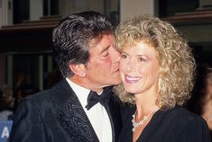 a man and woman kissing each other at an event