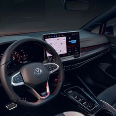 the interior of a car with steering wheel, dashboard and touch screen display showing information