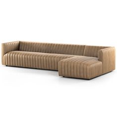 a beige couch sitting on top of a white floor