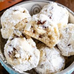 a bowl filled with cookies covered in powdered sugar