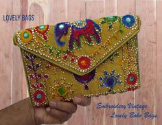 An elegant and aesthetically handcrafted clutch bag for gorgeous ladies which can be used in any occasion, from a ravishing night party to a traditional wedding or just for daily purpose. It is made by skilled Indian craftsmen with beautiful embroidery and right velvet touch. The embroidered elephant is a symbol of peace, wisdom and grandeur. We Have made successful series of Bags for Regular, Casual and Formal uses, with hand work or lovely prints Cotton Handbag. It is a perfect gift for your f Trendy Embroidered Shoulder Bag As Gift, Yellow Embroidered Travel Bag, Handheld Multicolor Bags With Handwork, Rectangular Handwork Bags For Travel, Yellow Embroidered Bag For Daily Use, Trendy Embroidered Pouch Bag, Rectangular Bags With Multicolor Embroidery As Gifts, Rectangular Travel Bag With Handwork, Rectangular Handwork Bags For Daily Use