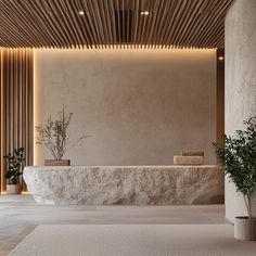 a large white counter sitting in the middle of a room next to two planters