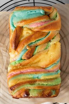 a loaf of bread with different colored frosting on it