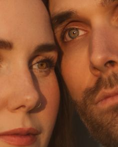 a close up of a woman and man looking at the camera with an intense look on their face