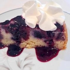 a piece of blueberry cheesecake with whipped cream on top