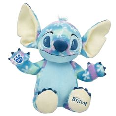 a stuffed animal that is blue and has an elephant on it's back legs