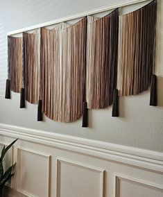 the wall is decorated with fringes and hanging from it's sides, along with a potted plant