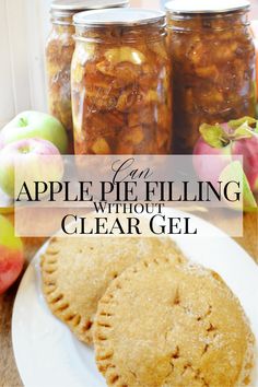 two apple pies sitting on top of a white plate next to jars of apples