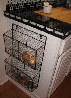 a kitchen counter with wire baskets on it