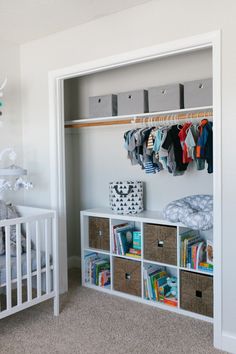 a baby's room with a crib, bookshelf and toy chest