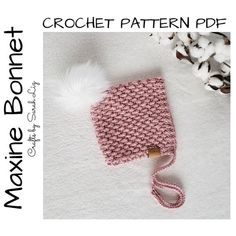 a crochet pattern for a baby's hat with a pom - pom