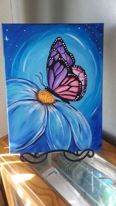 a painting of a butterfly on a blue flower