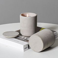 a white candle sitting on top of a book