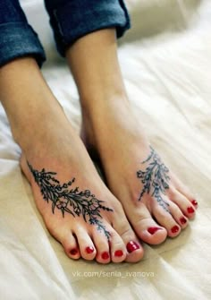 a woman's feet with tattoos on them