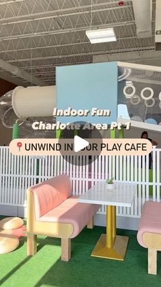 an indoor play area with benches, tables and other items on display in the background