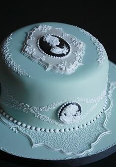 there is a blue cake with white decorations on it