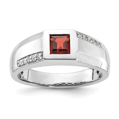 a white gold ring with a red stone and diamonds