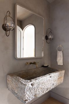 a bathroom sink sitting under a large mirror