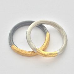 These contemporary silver and gold rings have an organic sculptural form and a modern feel.  Perfect everyday rings, comfortable to wear and ready to make a statement. Created from silver wire, hammered, forged, and heated with soldering torch to reticulate the silver surface, creating a subtle organic texture.  Gold is applied using Keum Boo, an ancient technique fusing 24 gold foil onto the surface of the silver. The gold foil leaves rich gold color. Available in two different finishes the photo represents a matt silver finish with gold and oxidized silver finish with gold.  Please specify your preference in finish option - Matt  - Oxidized - Matt/Oxidized Available as a set or individual.  Set $250, Single $150, please message me if you would like to set up a single ring purchase. Can b Organic Gold Ring, Hammered Metal Jewelry, Keum Boo Jewelry, Silver And Gold Rings, Contemporary Rings, Contemporary Jewellery Designers, Ancient Jewels, Keum Boo, Handmade Wedding Rings