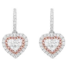 Beautiful Heart shaped Dangling earrings with certified White diamonds and Rare Pink diamonds. Heart Shape White Diamond (GIA Certified) - 0.50 cts Heart Shape White Diamond (GIA Certified) - 0.50 cts Pink diamond - 0.14 cts Round Brilliant cut white diamonds - 0.53 cts 18k Gold HYT Jewelry is a privately owned company headquartered in Hong Kong, with branches in Tokyo, New York, and Bangkok. The company specializes in fine jewelry. It is renowned for an exceptional range of Fancy Color Diamonds and Color Stones (including Colombian Emeralds and Burma Ruby) ranging from rare to the rarest in various hues and color intensities studded in the jewelry with the finest craftsmanship. HYT is committed to producing the finest and exquisite jewelry pieces with sophisticated state-of-the-art techno Pink Diamond Earrings, Gold Diamond Drop Earrings, Argyle Pink Diamonds, Pink Diamonds, Timeless Jewelry, Diamond Drops, Diamond Drop Earrings, Fancy Color Diamonds, Lovely Earrings