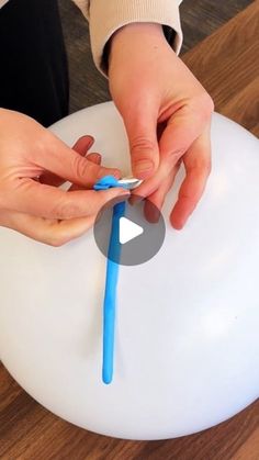 a person using a toothbrush to brush their teeth on an inflatable chair