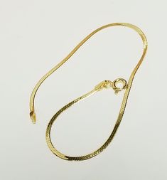 Thanks for shopping our vintage estate store. We tend to sell well below wholesale and truly hope you enjoy all of our items. Many of the items are one of a kind, so please enjoy scrolling through the pictures and hopefully something will catch your eye. Black spots are from camera or reflections.  14k yellow gold herringbone bracelet.  Retails: $599 on sale $169 Size: please select Width: 1.5mm 1/8" Weight: .86 to 1.0 gram Bright gold which reflects the camera. As with all our gold it's marked 14k, with spring clasp. Stunning. Herringbone Bracelet, Yellow Gold Bracelet, Bright Gold, Black Spot, Eye Black, Herringbone, Gold Bracelet, Jewelry Necklaces, Yellow Gold