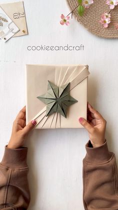 a person holding up a box with a star on it and the words cookie and craft above it