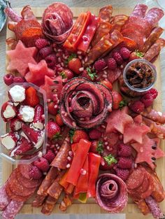 a wooden cutting board topped with lots of meat and veggies on top of it