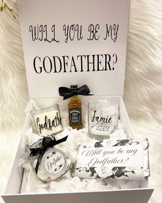 a gift box with candles, soap and other personal items in it that says will you be my godfather?