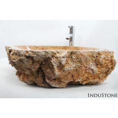 a sink made out of rocks with a faucet