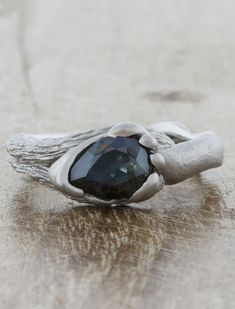 a silver ring with a black stone on it