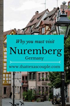 a blue sign that says why you must visit nuremberg germany with bicycles parked in front