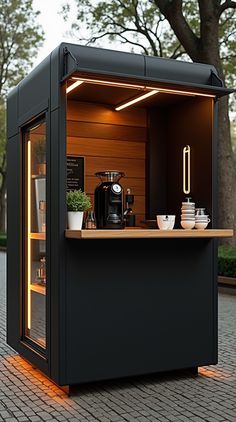 an outdoor coffee shop with lights on the outside