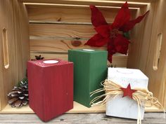 three wooden boxes with christmas decorations in them