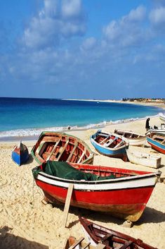 there are many small boats on the beach