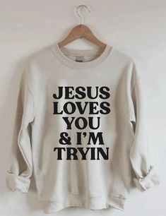 Jesus Loves You i'm Tryin Christian Sweatshirt, Bible Verse Sweatshirt, Aesthetic Christian Sweatshirts, Jesus Sweatshirt, Church Sweatshirt Welcome to Bee Design Gifts If you are looking for soft, comfy, first-rate sweatshirts, you're in the right place! I love what I do and strive to make your shopping experience just right for you. If you have any questions, concerns or comments about my products, feel free to send a message anytime. ⭐ 50% cotton, 50% polyester ⭐ Pre-shrunk ⭐Classic fit ⭐ 1x1 athletic rib knit collar with spandex ⭐ Air-jet spun yarn with a soft feel and reduced pilling ⭐Double-needle stitched collar, shoulders, armholes, cuffs, and hem HOW TO PLACE ORDER 1. Check photos for size chart, model comparison and color options 2. Select size and color from the drop down option Jesus Loves You Tee Shirt, Christian Sweatshirts Storage, Christian Sweatshirts, Aesthetic Christian, Jesus Sweatshirts, Sweatshirt Aesthetic, Jesus Love, Retro Sweatshirts, Cute Shirt Designs