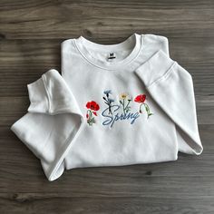 Step into a world of natural elegance with our latest Wildflower Sweatshirt Collection - where comfort meets botanical beauty in every stitch! Crafted from soft, high-quality materials, our sweatshirts are as cozy as they are chic.  Whether you're an avid nature lover, a free spirit at heart, or simply someone who appreciates the beauty of the great outdoors, our Wildflower Sweatshirt Collection invites you to bring a touch of the wild into your everyday wardrobe. Pair them with your favorite je Spring Long Sleeve Tops With Embroidered Logo, Long Sleeve Tops With Embroidered Logo For Spring, Spring Crew Neck Sweatshirt With Embroidered Logo, Spring Sweatshirt With Embroidered Logo And Crew Neck, Spring Casual Sweatshirt With Embroidered Graphics, Casual Embroidered Sweatshirt For Spring, Spring Crew Neck Sweatshirt With Embroidered Graphics, Spring Sweatshirt With Embroidered Graphics And Crew Neck, Relaxed Fit Tops With Letter Embroidery For Spring