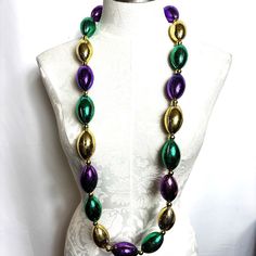 Mardi Gras Football Krewe Throw Purple Green Gold Beads Nwt New With Tags New Old Stock - 2004 Large Football Purple Green Gold Great For Party Decor Or Wear To Mardi Gras Get Ready For Super Bowl 21” Drop Buy In Multiples Of Three And Get 20% Off Oval Beaded Chain For Party, Party Beaded Necklaces With Colorful Oval Beads, Party Beaded Necklaces With Oval Beads, Colorful Oval Beaded Necklaces For Party, Round Beads Jewelry For Mardi Gras Party, Colorful Beads Jewelry For Mardi Gras Party, Colorful Beaded Jewelry For Mardi Gras Party, Wire Choker Necklace, Vintage Choker Necklace