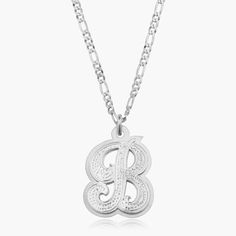 Our popular Double Plated Iced Out Initial Necklace boasts a chic and elegant design, handcrafted to perfection. The model showcases the necklace with an 18-inch Figaro chain (see video for reference). You can personalize this item with Letters, Numbers, and Roman Numerals and choose from chain lengths of 14", 16", 18", and 20". Each chain features a lobster clasp closure for secure wear.Chain width:Cuban Chain - 3.7 mmFigaro Chain - 3 mm Classic Initial Pendant Necklace With Chain, Classic Chain Necklace With Initial Pendant, Silver Necklace With Adjustable Chain In 14k Gold, Silver 14k Gold Charm Necklace With Adjustable Chain, Classic Silver Initial Pendant Chain Necklace, Classic Silver Chain Necklace With Initial Pendant, Classic Chain Necklace With Polished Finish For Gift, Classic Polished Chain Necklace Gift, Classic Polished Chain Necklace As Gift