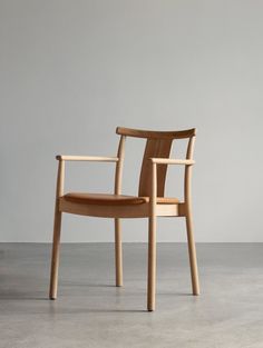 a wooden chair sitting on top of a cement floor