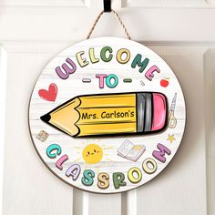 a welcome sign hanging on the front door with a crayon pencil in it