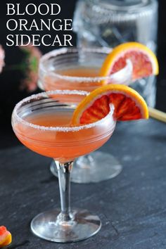 two margaritas with grapefruit and orange garnish