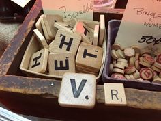 scrabble tiles spelling out the word love and other words in a wooden box