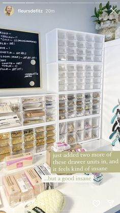 an organized desk with clear drawers and white chalkboard on the wall behind it, along with text that reads just added two more of these drawer units,