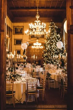 the dining room is decorated for christmas with white tablecloths and gold tables cloths