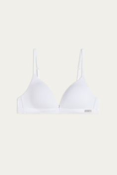 Tiziana triangle bra in cotton with lightly padded cups. Wireless cups with side boning and cotton lining. A hook on the strap adjusters allows you to cross the straps in the back to create a racerback fit, or to hide them for certain necklines. Created for those looking for simple, practical styles. This item runs small. Cotton Bra With Padded Cups, Classic Push-up Bra With Adjustable Straps, White Spaghetti Strap Bra With Adjustable Straps, White Low-cut Bra With Adjustable Straps, May Sign, Triangle Bra, Lingerie Collection, Bra Women, Clothes Collection