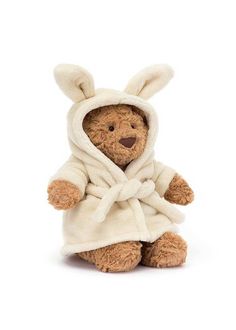 a brown teddy bear wearing a white robe and bunny ears on it's head