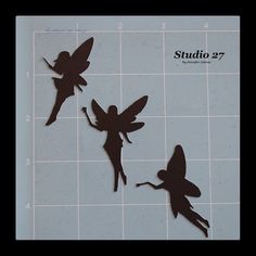 three cut outs of tinkerbells on a tile background with the words studio 27 below them