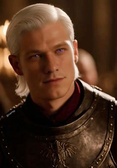 the white haired man with blue eyes is dressed in armor and looking at the camera