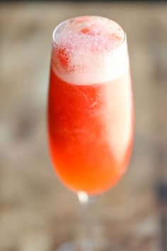 a close up of a wine glass filled with liquid